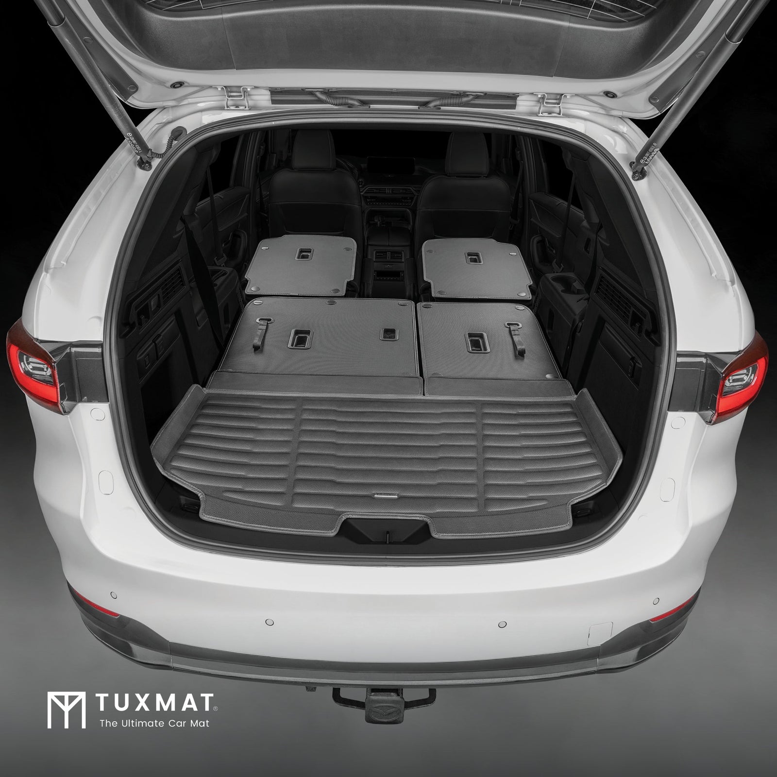 Open car trunk with a TuxMat car mat installed, showing the product's fit and design.