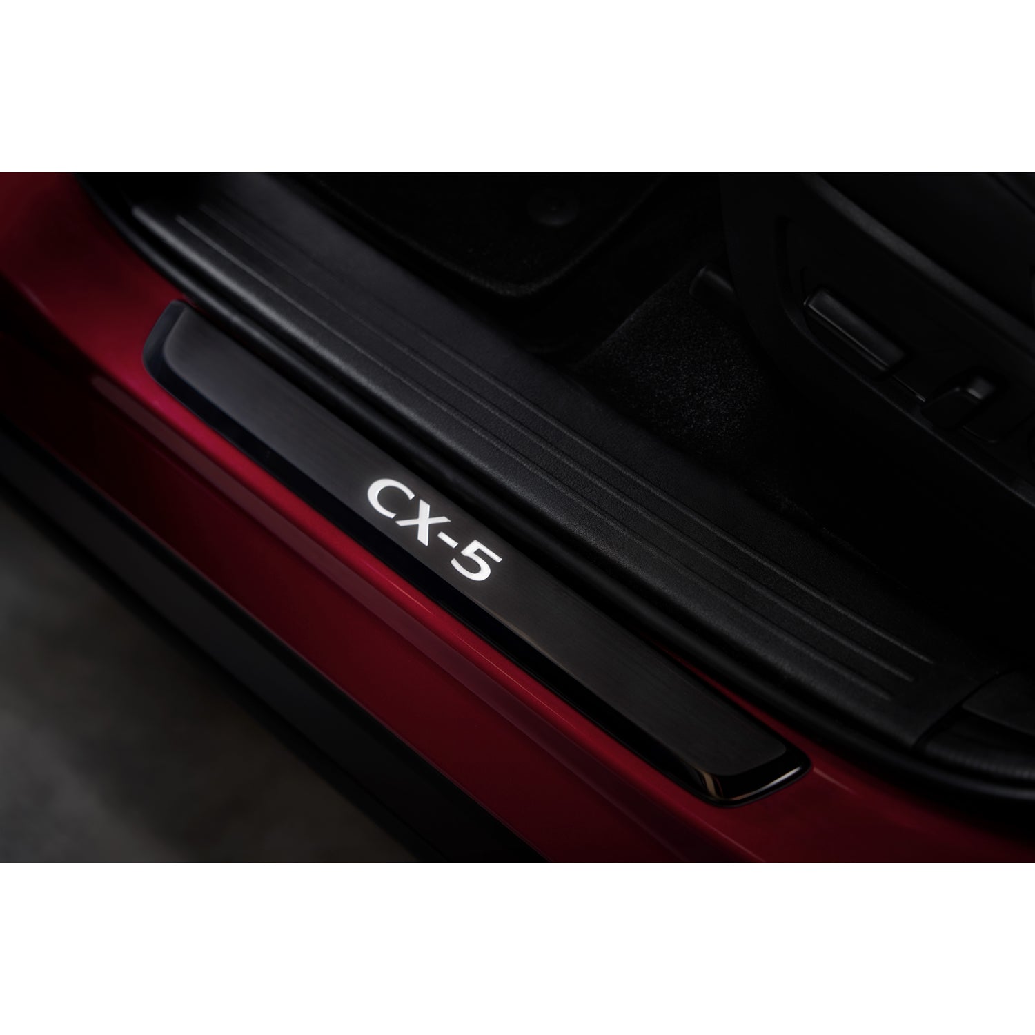 Black Door Sill Trim Plate with illuminated CX-5 logo on red vehicle