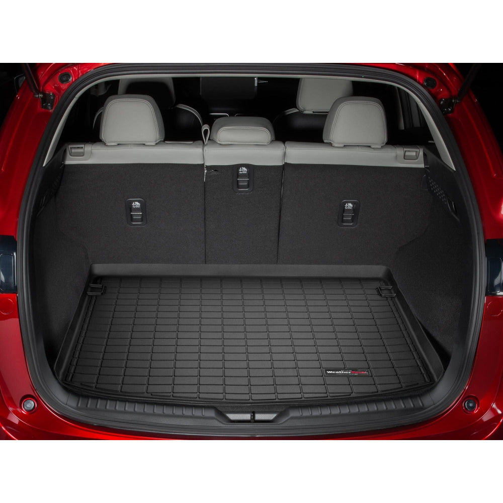 Car trunk with a black cargo liner and visible Weathertech logo.