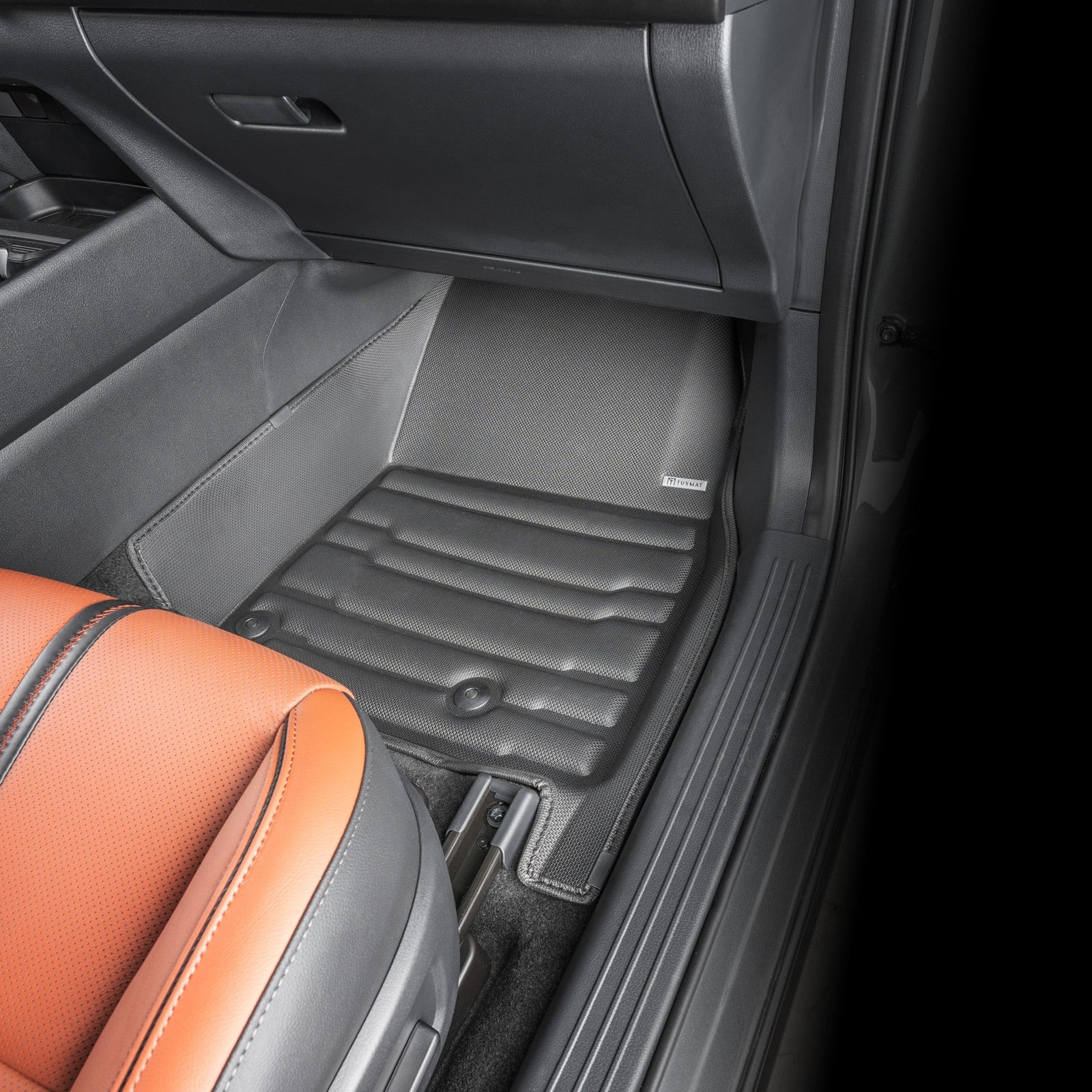 Car interior with gray floor mats and orange seat
