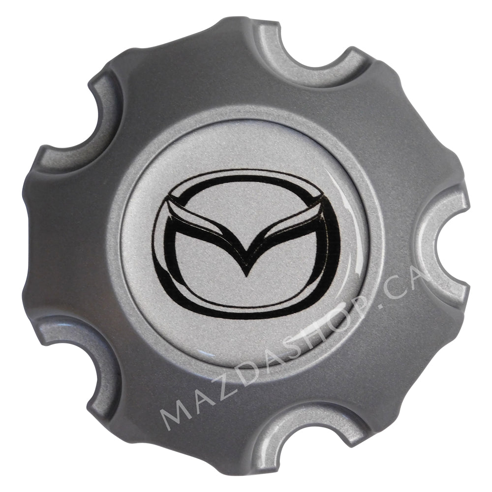 Silver Mazda wheel cap with the Mazda logo on a white background