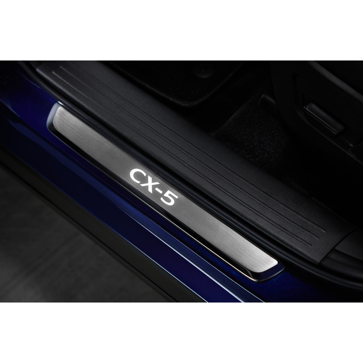 Silver Door Sill Trim Plate with illuminated CX-5 logo on blue vehicle